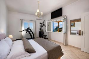 a bedroom with a bed and a window at Anchor House Santorini in Fira