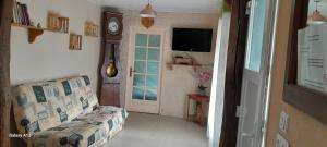 a living room with a couch and a tv at La crapaudiere in Charrin