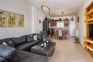 a living room with a couch and a table at Anchor House Santorini in Fira +7 photos