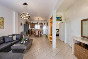 a living room with a couch and a table at Anchor House Santorini in Fira