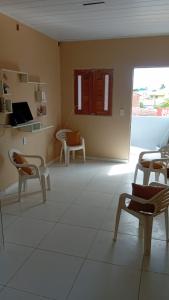 a room with chairs and a room with a window at Espaço Mãe Cecília in Paripueira