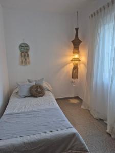 a bedroom with a bed with two lights on it at CasaMora departamento céntrico con cochera gratis, 2 habitaciones in Almafuerte