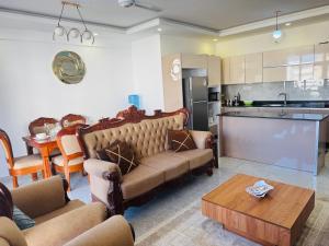 a living room with a couch and a table at Giannas stays 3B in Mombasa