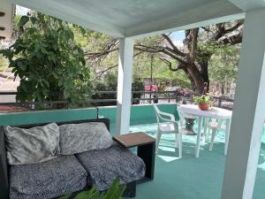 a porch with a couch and a table on a patio at Casa Buenavista in Mérida
