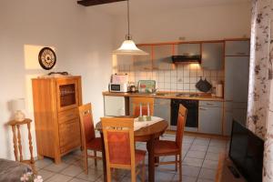 a kitchen with a table and a dining room at FeWo 2 - Haus Lorenzen in Hörsten