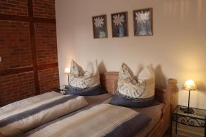a bedroom with two beds with pillows on them at FeWo 2 - Haus Lorenzen in Hörsten