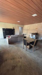 a room with a bed and a table and chairs at Rancho Helena in Maceió +4 photos