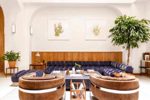 a living room with a couch and a table at Tilden Hotel Union Square in San Francisco