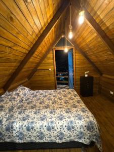 a bedroom with a bed in a attic at A Cabana Caiçara in Ilhabela