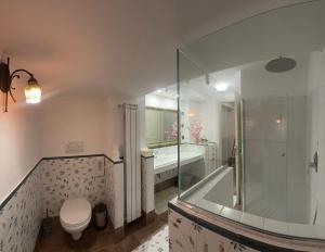 a bathroom with a tub and a toilet and a shower at Linda's Retreat B&B in Fiano Romano +56 photos