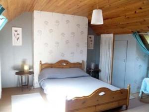a bedroom with a bed and a wooden ceiling at KERMARIUs in Plougastel-Daoulas