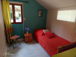 a bedroom with a red bed and a window at KERMARIUs in Plougastel-Daoulas +3 photos