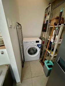 a small laundry room with a washing machine in it at Les Sibylles in Châtellerault