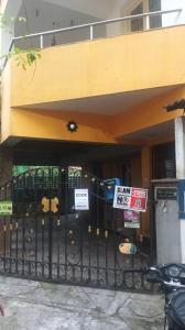 a gate in front of a building with signs on it at Comfort Zone in Chennai