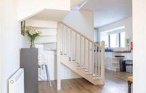 a staircase in a house with a vase of flowers at 3 Carbost in Tole
