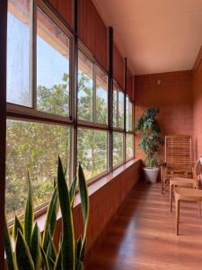 a room with windows and a potted plant at Alloos homestay villa in Attappādi