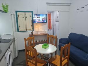 a living room with a table and chairs and a couch at Casa OASIS in Almonte +15 photos