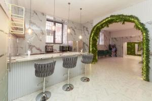a kitchen with an arch and stools in a room at Guest House Partenope in Naples