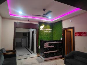 a room with a green wall with a sign on it at Greenland Premium Hotel in Bhubaneshwar