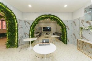 a room with an arch with tables and a tv at Guest House Partenope in Naples
