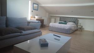 a living room with a couch and a bed at Les Deux Chambres Aucamville in Aucamville +8 photos