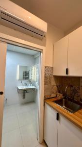 a kitchen with white cabinets and a sink at Canoa Studio Vlc & Free filtered drinking water in Valencia
