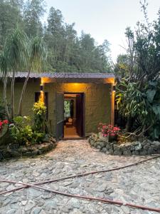 a house with a pathway leading to a door at Arroyo Frío River Lodge in Arroyo Frío