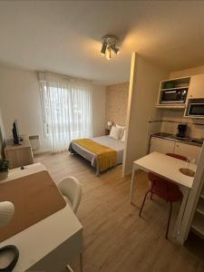 a small hotel room with a bed and a kitchen at Sphinx Résidences - Tempologis Mémorial in Caen +70 photos