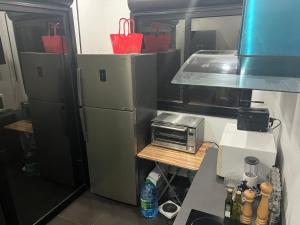 a kitchen with a refrigerator and a toaster oven at Therese Home in Ngor