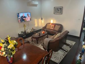 a living room with a couch and a table at Therese Home in Ngor