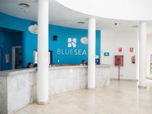 a bar in a building with a blue wall at BLUESEA Costa Teguise Gardens in Costa Teguise