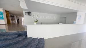 a lobby with a white counter in a building at BLUESEA Lagos de Cesar in Puerto de Santiago