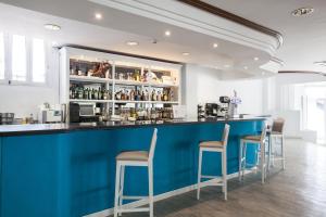 a blue bar with stools in a room at BLUESEA Lagos de Cesar in Puerto de Santiago