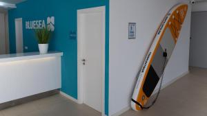 a room with a surfboard leaning against a wall at BLUESEA Anba Romaní in Cala Millor +42 photos