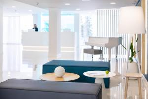 a living room with a blue couch and a table at BLUESEA Interpalace in Puerto de la Cruz