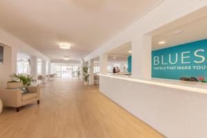 an office lobby with a blue sign on the wall at BLUESEA Don Jaime in Cala Millor
