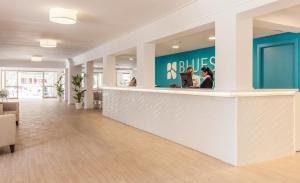 a lobby of a building with a reception counter at BLUESEA Don Jaime in Cala Millor