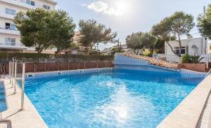 a swimming pool with blue water in a building at BLUESEA Don Jaime in Cala Millor +29 photos