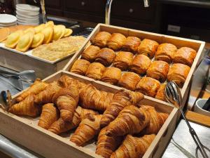 a display of croissants and other pastries in boxes at ibis Albert Pays de Somme in Albert