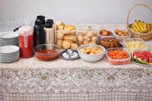 a table with bowls of food on a table at Palace Hotel in Anápolis