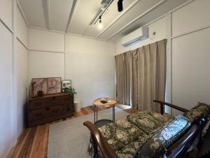 a bedroom with a bed and a table in it at SAUNA HOUSE Yutagawa in Tsuruoka