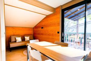 a dining room with a table and a couch at Prestige Chalet 50 in Rivières