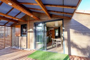 a house with a glass door on a deck at Prestige Chalet 50 in Rivières