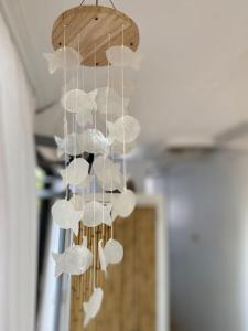 a chandelier with white butterflies hanging from a ceiling at Glamping Algarve Olive Tree Lodge in Nora