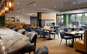 a restaurant with tables and chairs and a fireplace at Hotel Alpenrock Breckenridge, Curio Collection by Hilton in Breckenridge