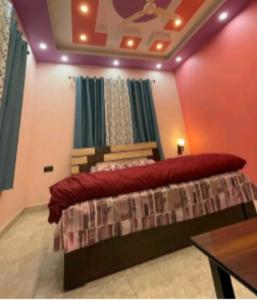 a bedroom with a bed with a red pillow on it at Sariyal Homestay in Kandikhal