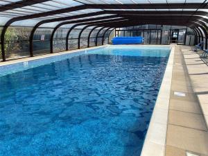a large swimming pool in a building with blue water at 3 Bed in Corton oc-s32347 in Corton
