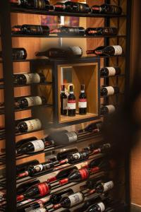 a wall of wine bottles in a wine cellar at Villa Garden Boutique Hotel Tirana in Tirana