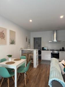 a kitchen and living room with a table and chairs at Orballo in Vilagarcia de Arousa