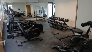a gym with rows of exercise equipment in a room at QUEEN ANGEL condo in Cozumel